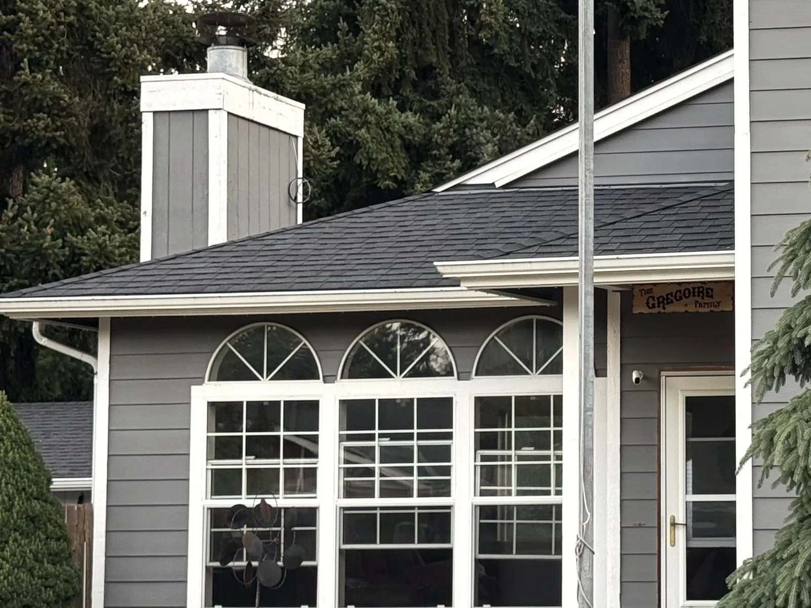 Gray siding, trim and arched windows on a home finished by All Home HX