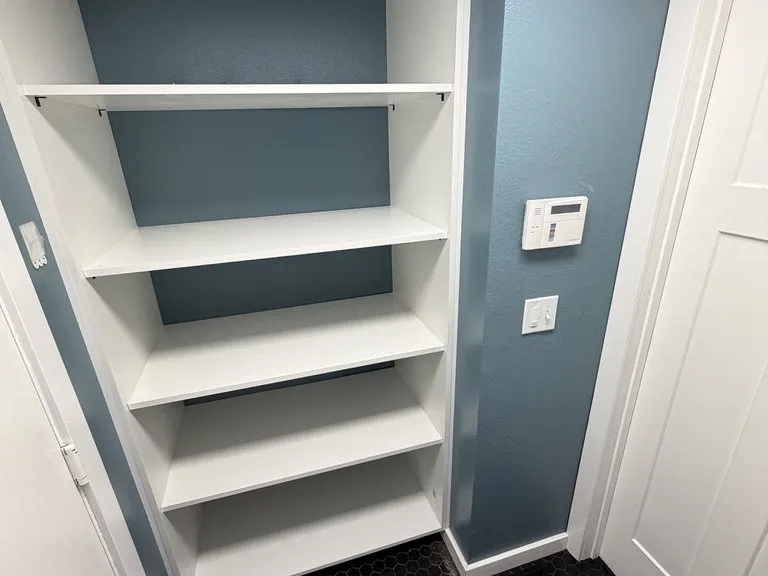 Built-in shelving painted into a blue alcove