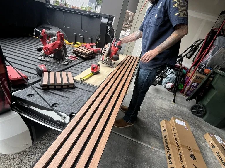 A crew member setting out the timber slats for a feature wall