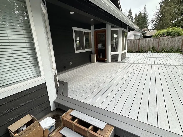 A grey composite deck built out from the back of the house