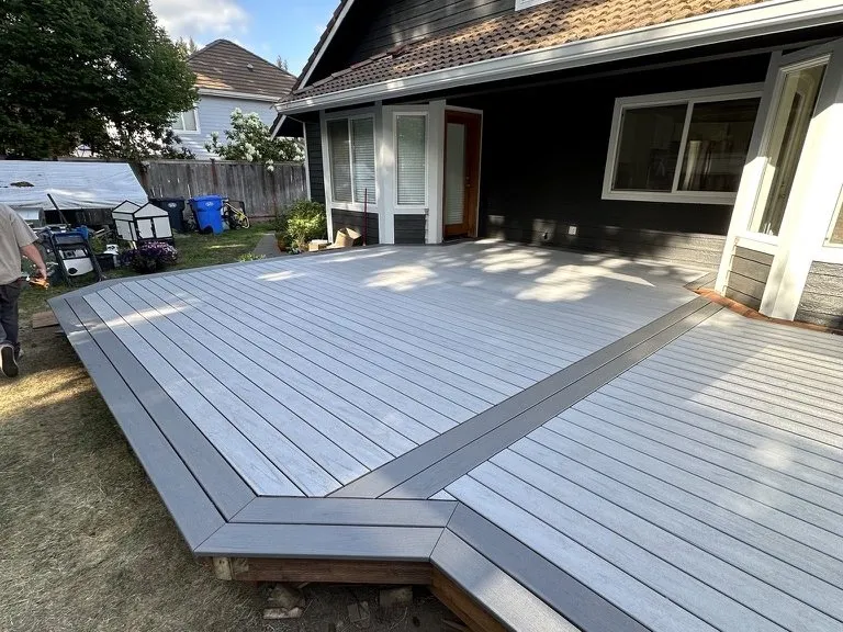 A wide composite deck running the length of the house