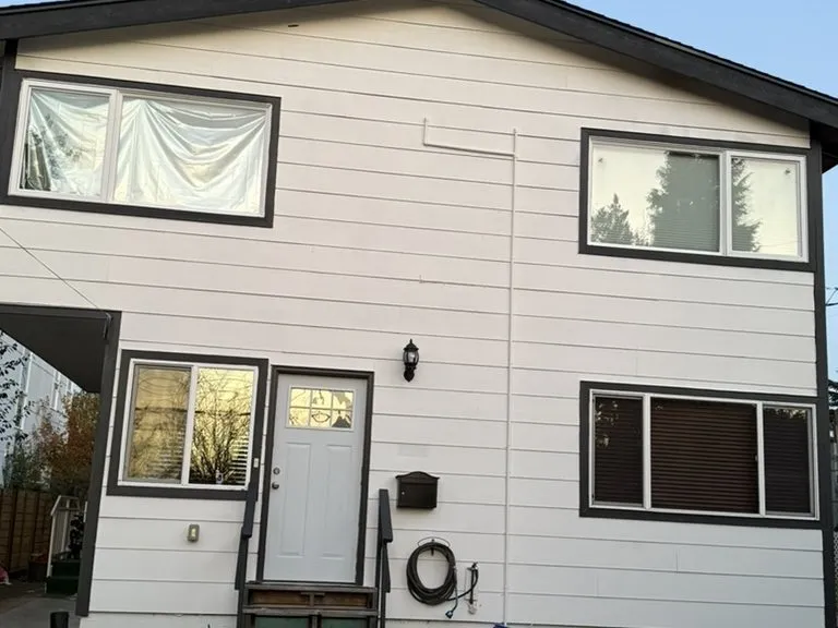 A finished white exterior with new trim