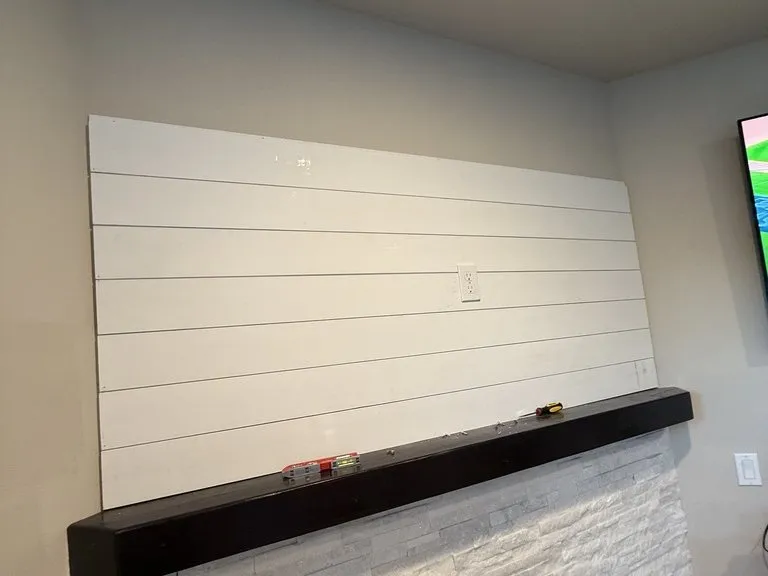 The finished shiplap chimney breast, with a floating timber mantel over stone