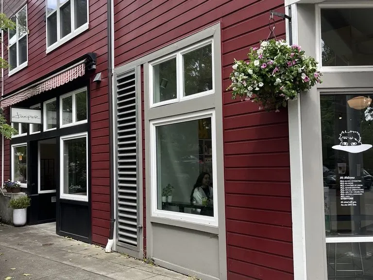The finished storefront, with new windows and a hanging basket