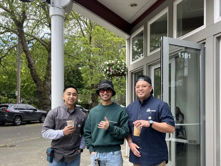 Three people outside a storefront All Home HX helped finish