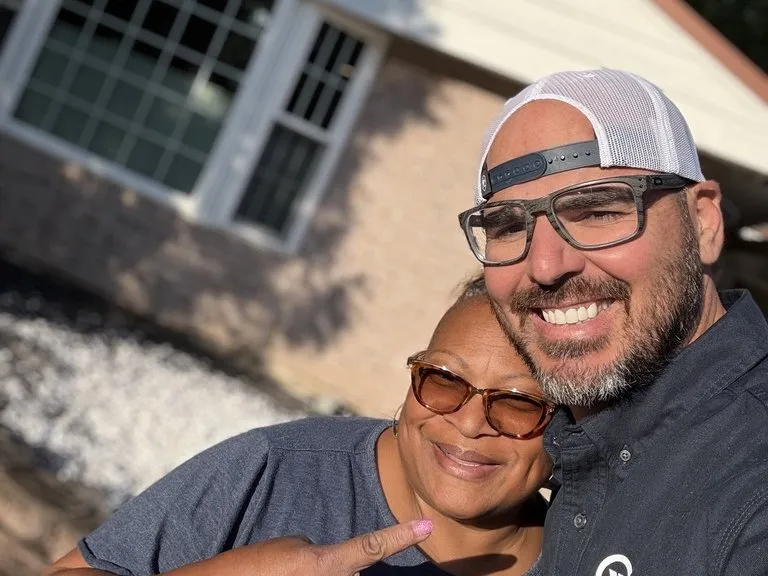 An All Home HX team member and a community member after a good-deed project