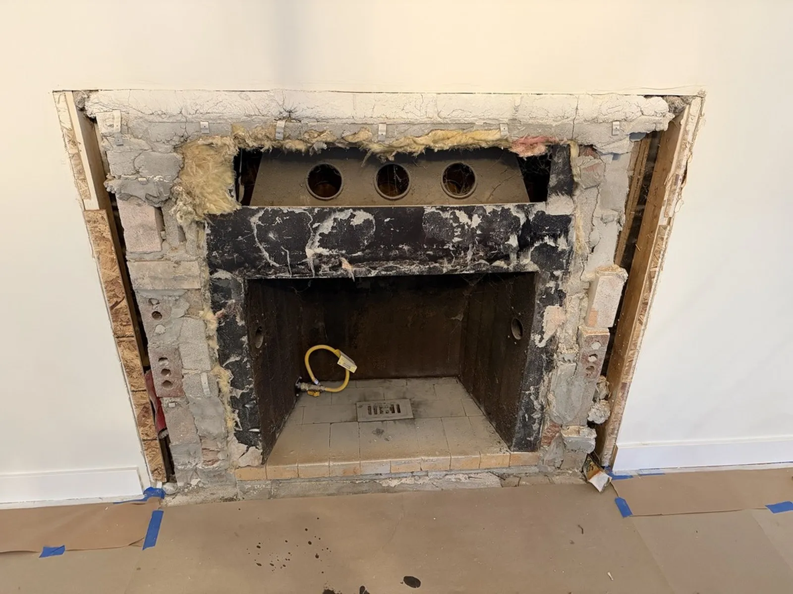 The fireplace stripped back to the original brick and blockwork before rebuilding