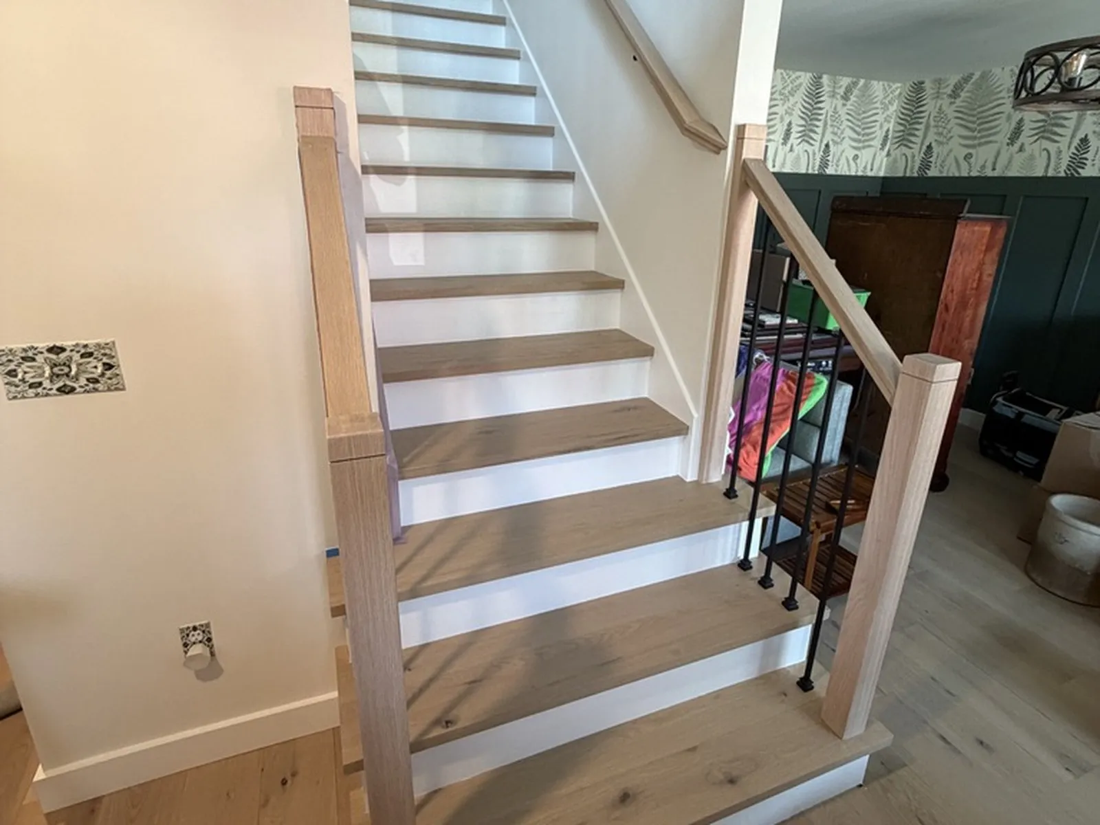 The same staircase finished, with white risers, oak treads and a new railing
