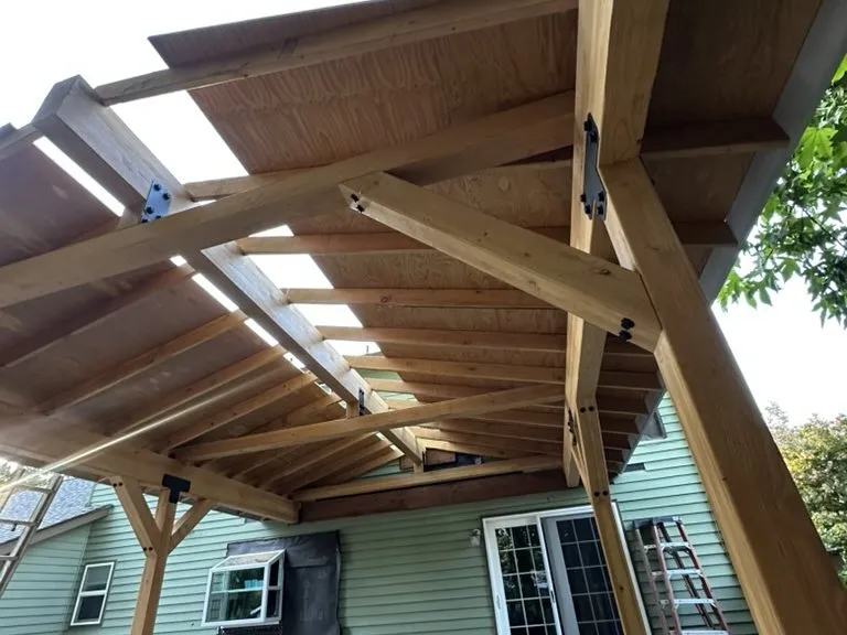Timber trusses going up on a new covered patio