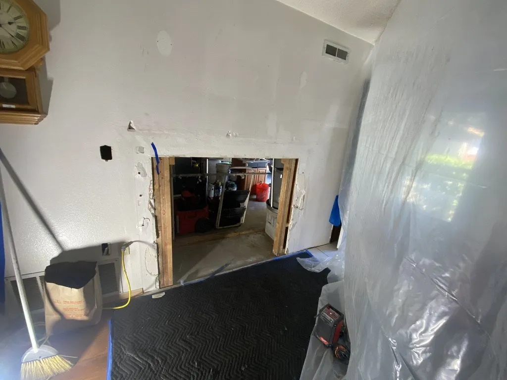 A doorway sealed in plastic sheeting before repair work begins