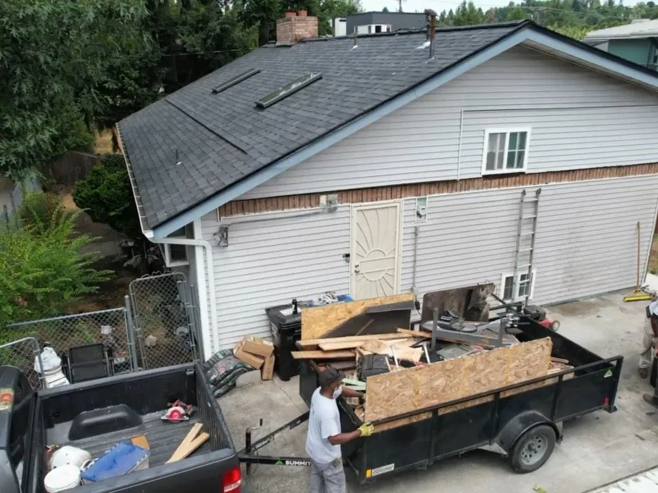 A crew member loading the debris trailer on a repair job