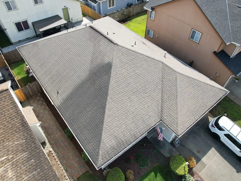 A completed shingle roof on a hip-roofed home