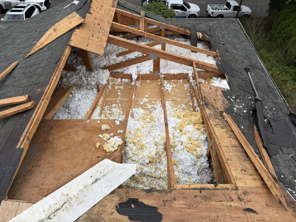 A roof stripped back to the rafters during a tear-off