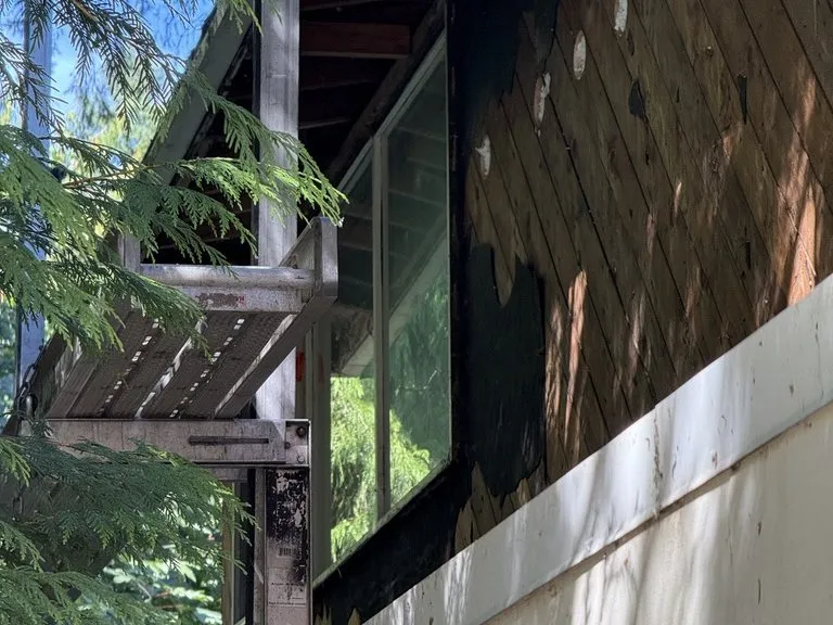 Siding stripped back to the house wrap before re-siding