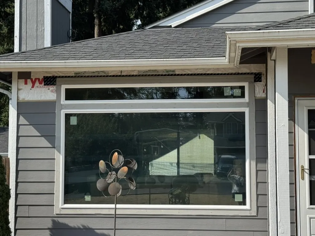 A new bay window fitted, with house wrap still exposed at the corner