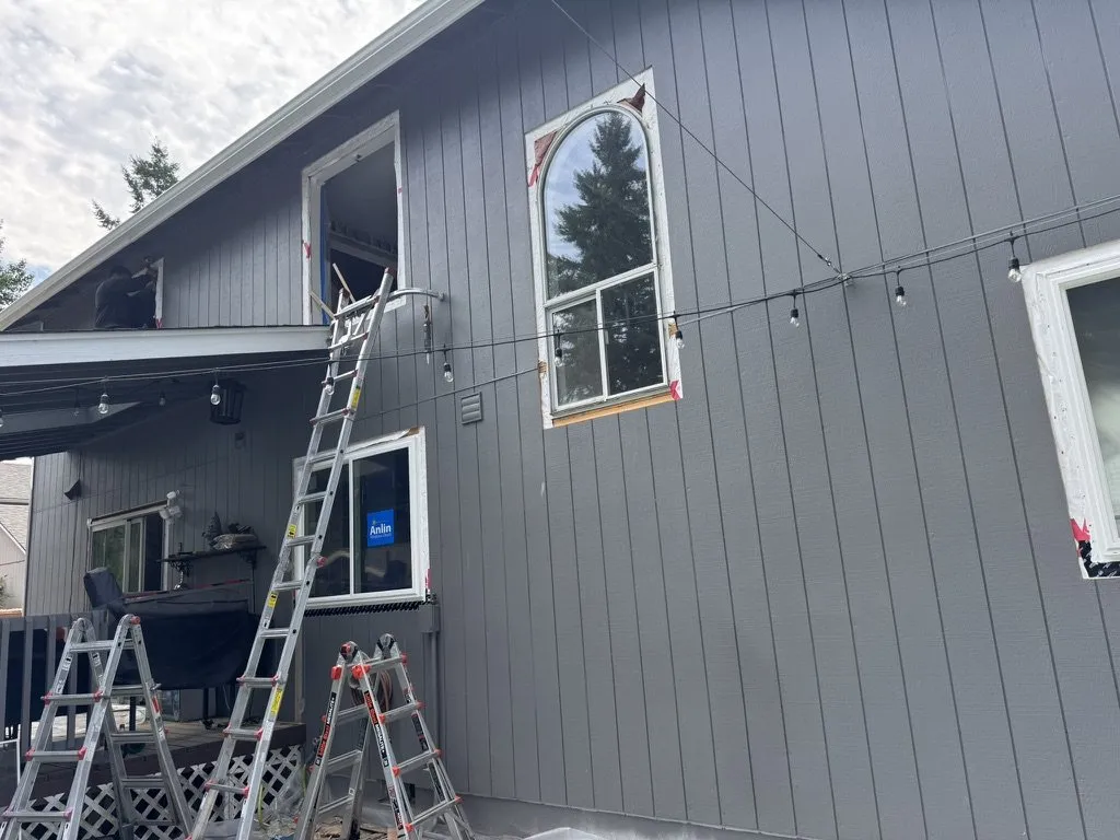 Ladders set against the house to fit a new upper window