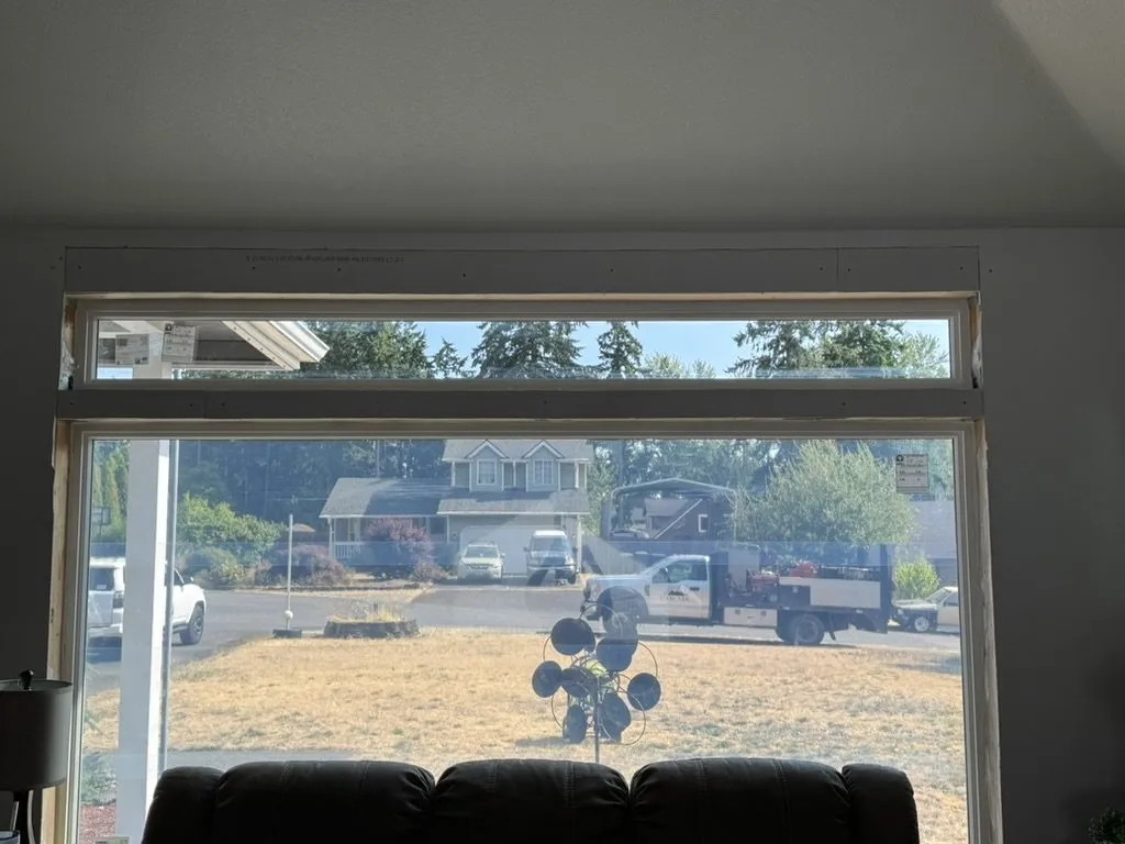 A large new picture window looking out over the yard